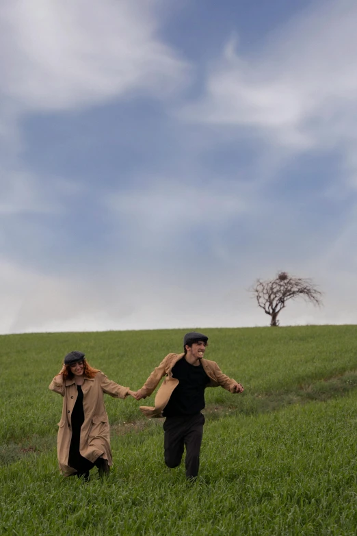 a man and woman walk in the middle of a field