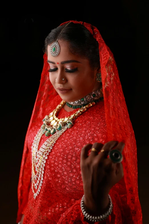 a beautiful indian bride holding soing with her hand