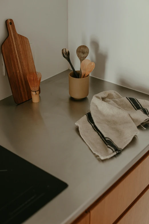 a kitchen counter top with a knife, spoons and utensils