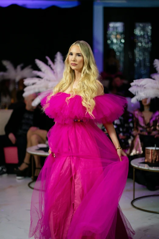 a model walks down the runway at the evening fashion show