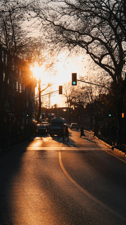 an empty street with the sun reflecting off the building windows