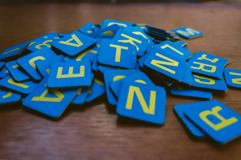 a bunch of name tags on top of a wooden table