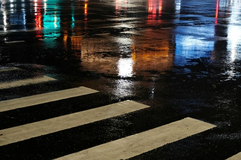 a crosswalk in a city at night with lights