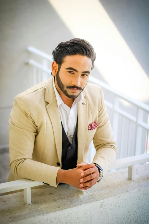 man with goatee wearing suit and tie with white shirt