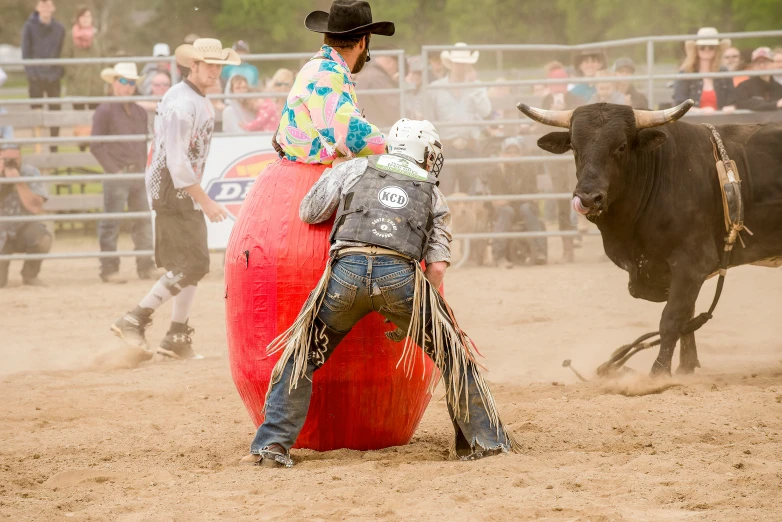 a couple of people are around a large ball