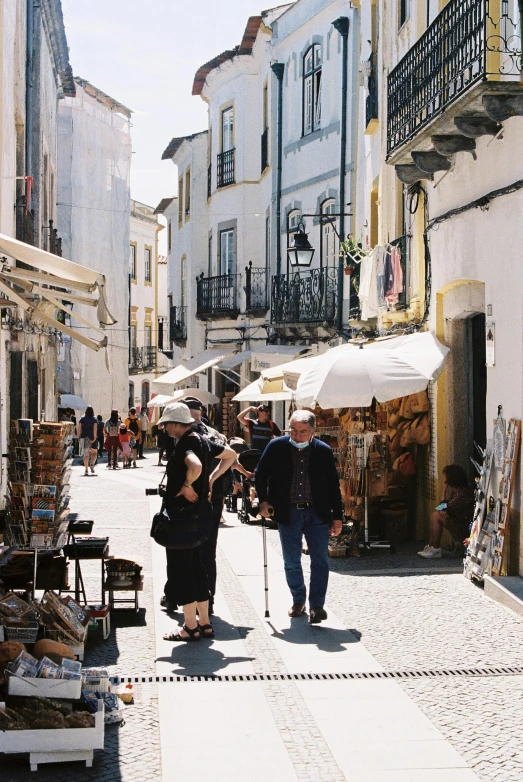 the man and woman are walking together down the street