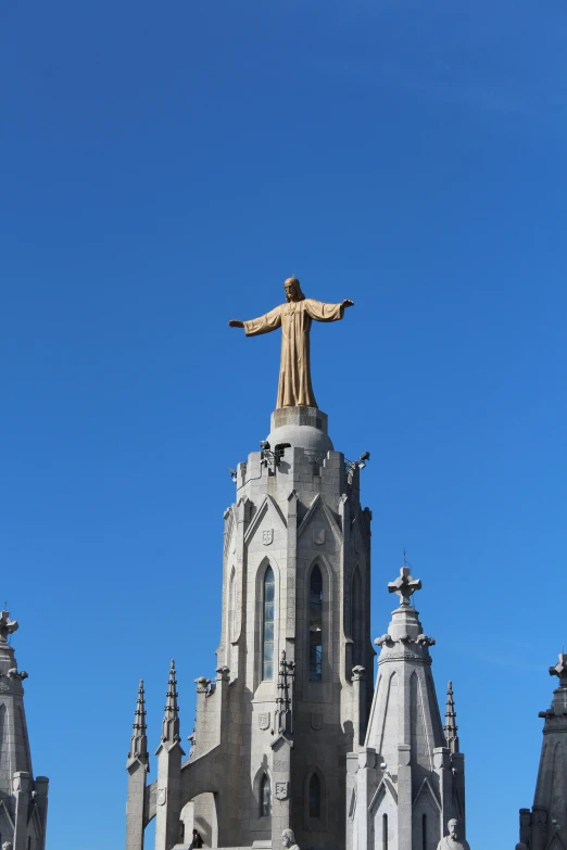 a very tall building with a large statue on top