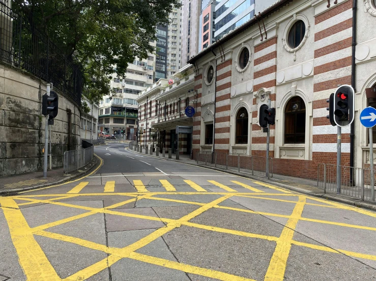 an empty street with red traffic signals and markings