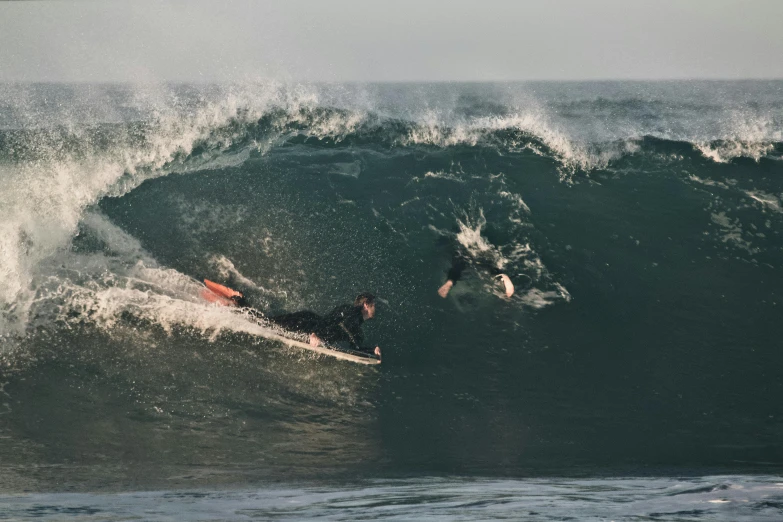 a surfer that is riding a very big wave