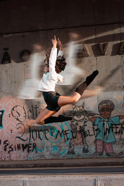 a skate boarder jumping in the air over a concrete wall