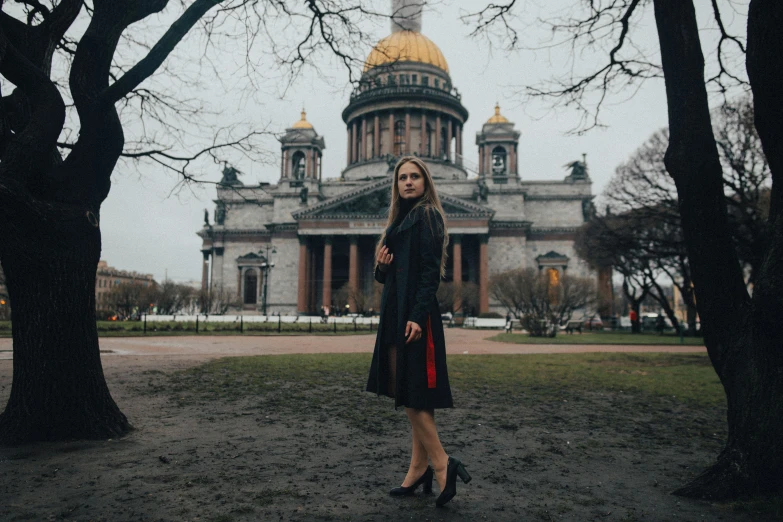 woman standing in front of old state house in winter