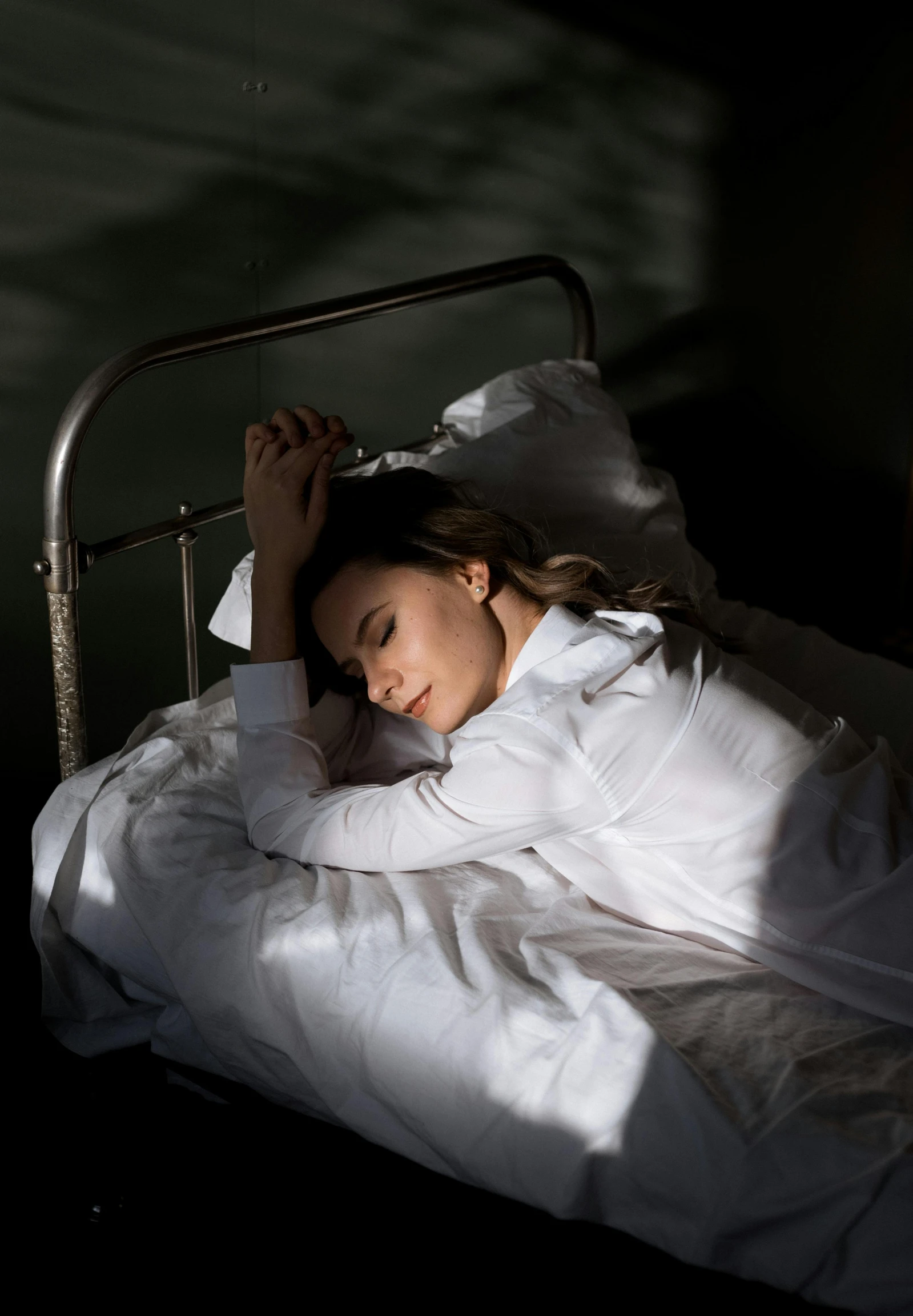 a young lady laying in bed while sleeping