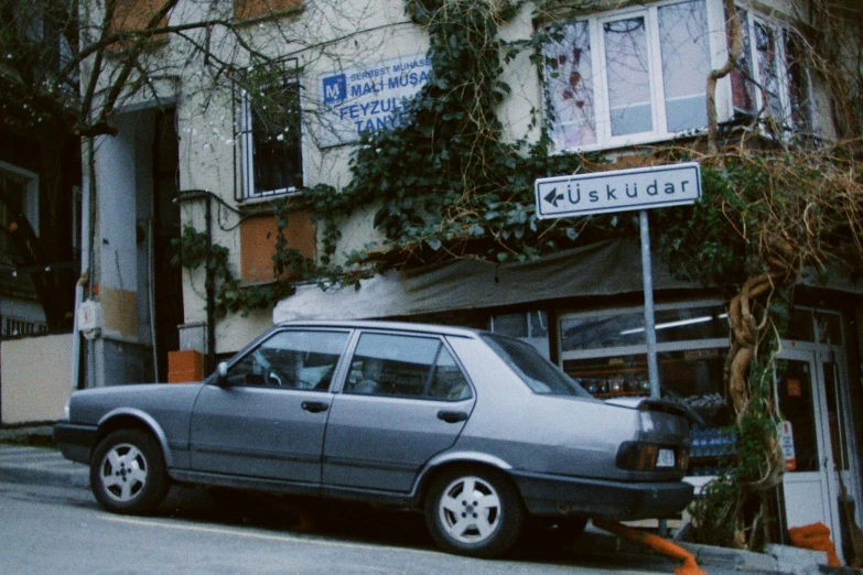 an old car parked next to a building