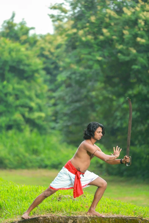 a person holding a sword with his right hand