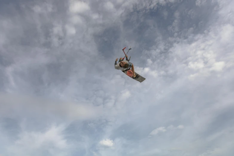 a person on a snowboard high in the sky