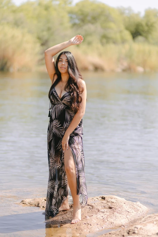 a woman standing in the water at a river