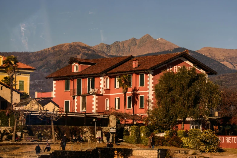 an orange building is in the foreground with mountains in the background