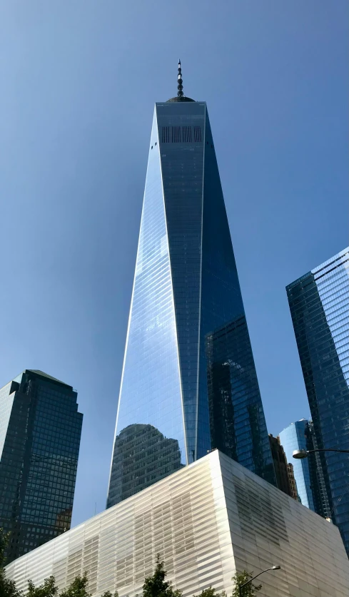 a tall skyscr building sitting next to another tall building