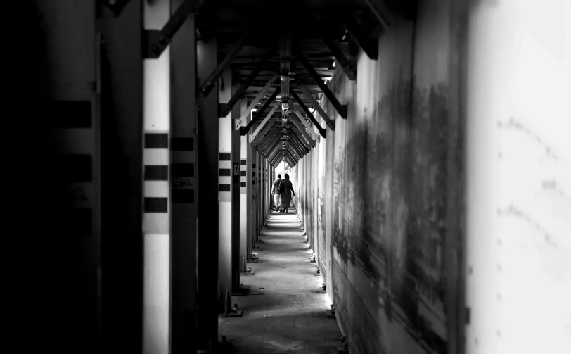 black and white pograph of two people walking down a path