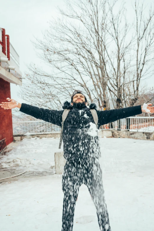 woman standing on snow covered ground in front of tree