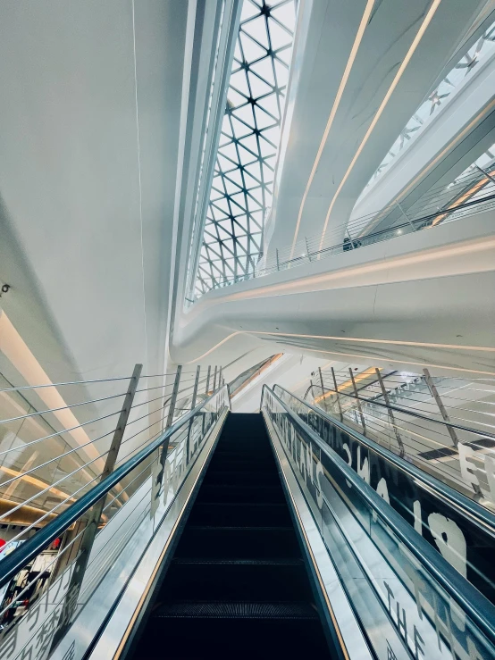 the escalator in an airport with a skylight