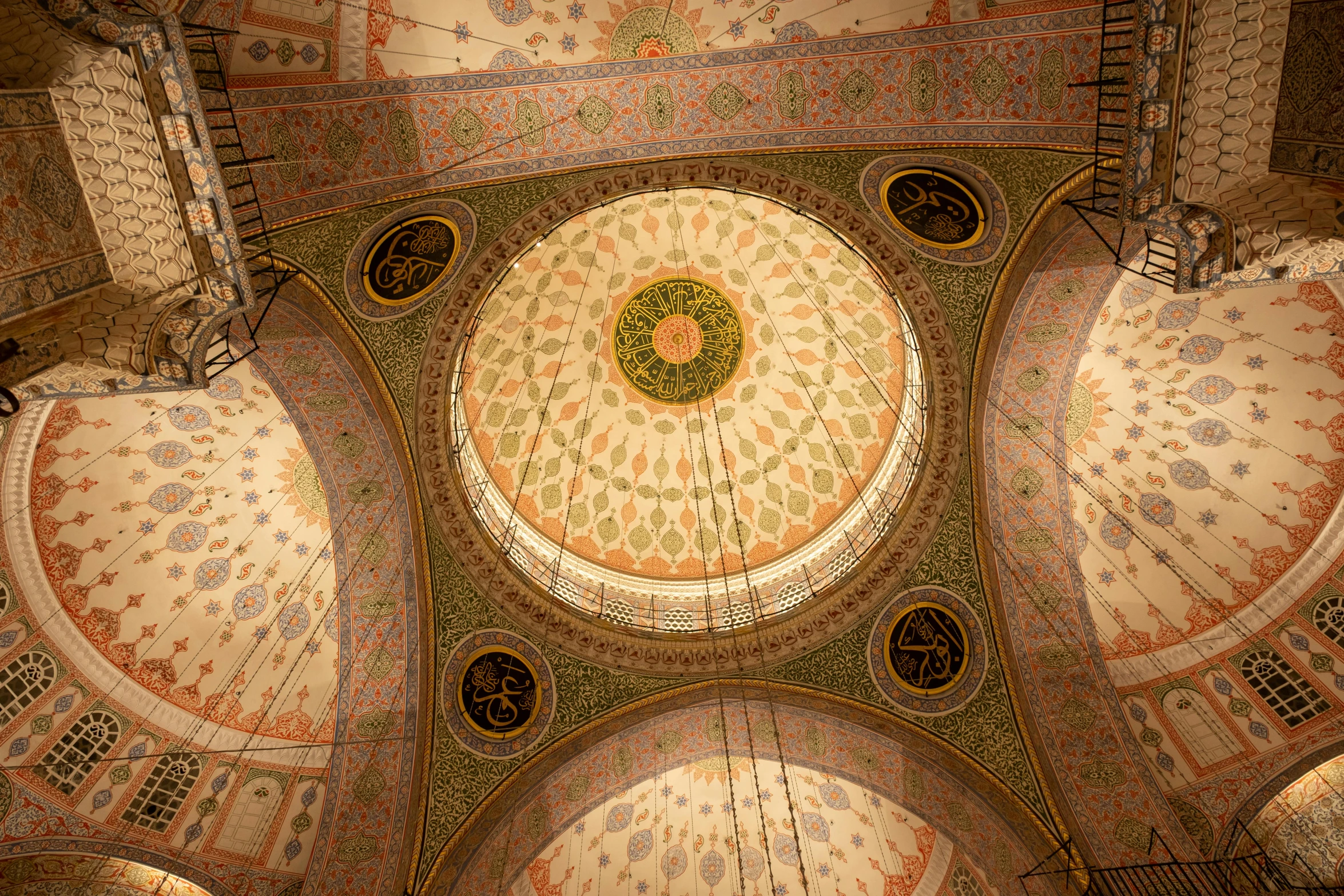 the ceiling of a building decorated with tiles and designs