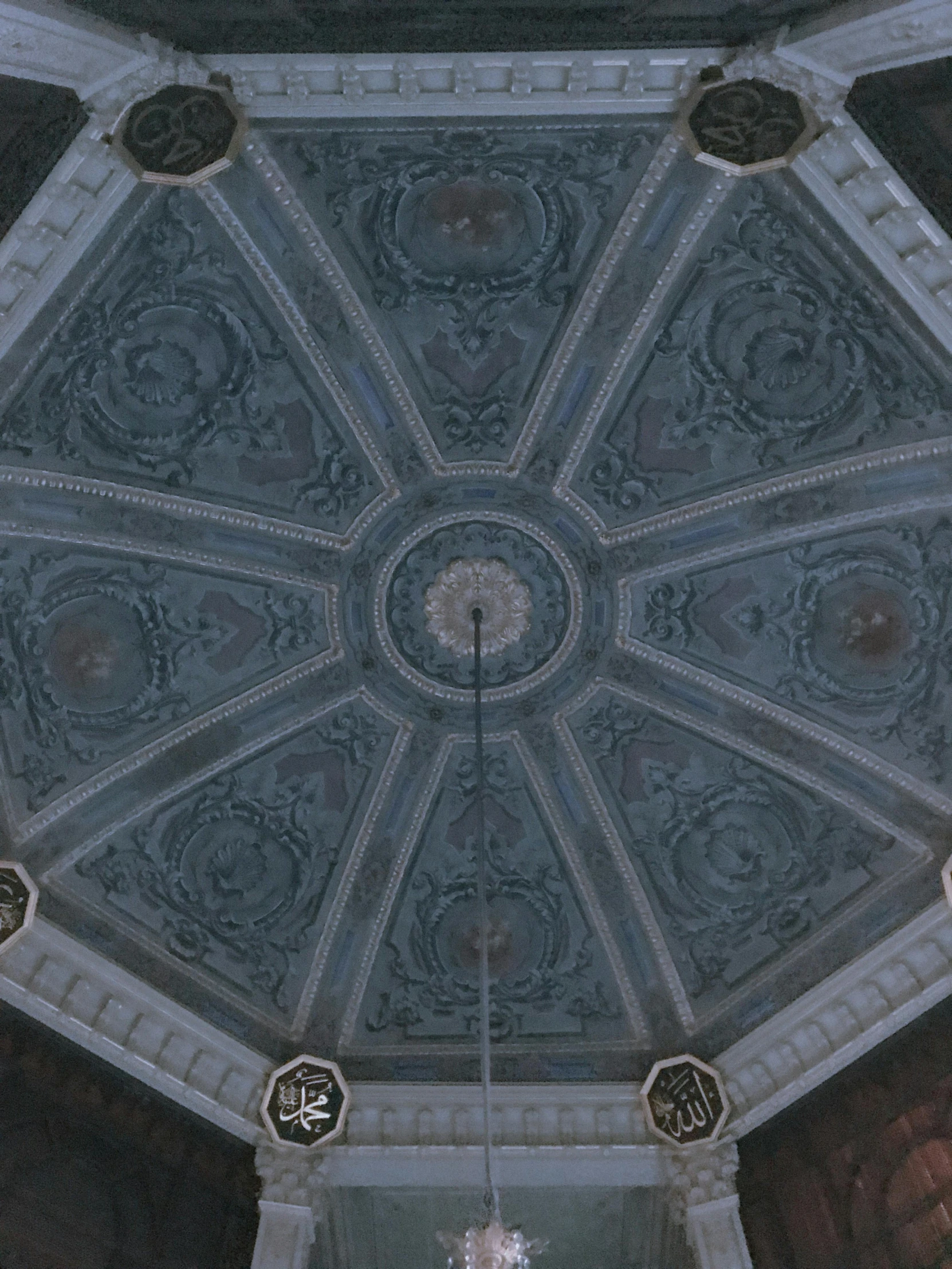 an ornate ceiling with many windows and decorated clocks