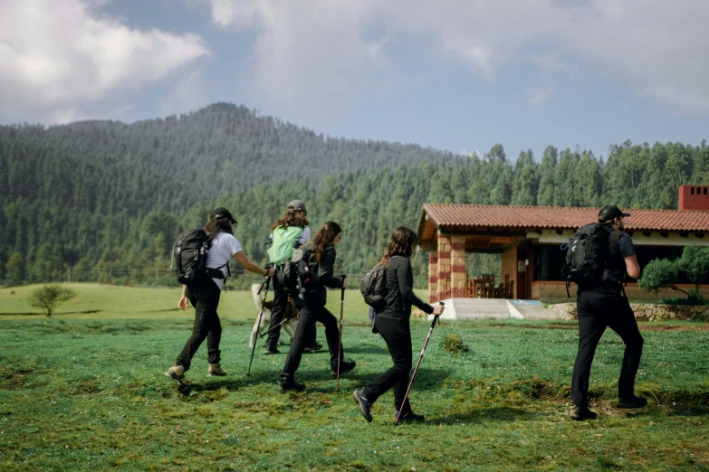 group of people on a field in front of a house