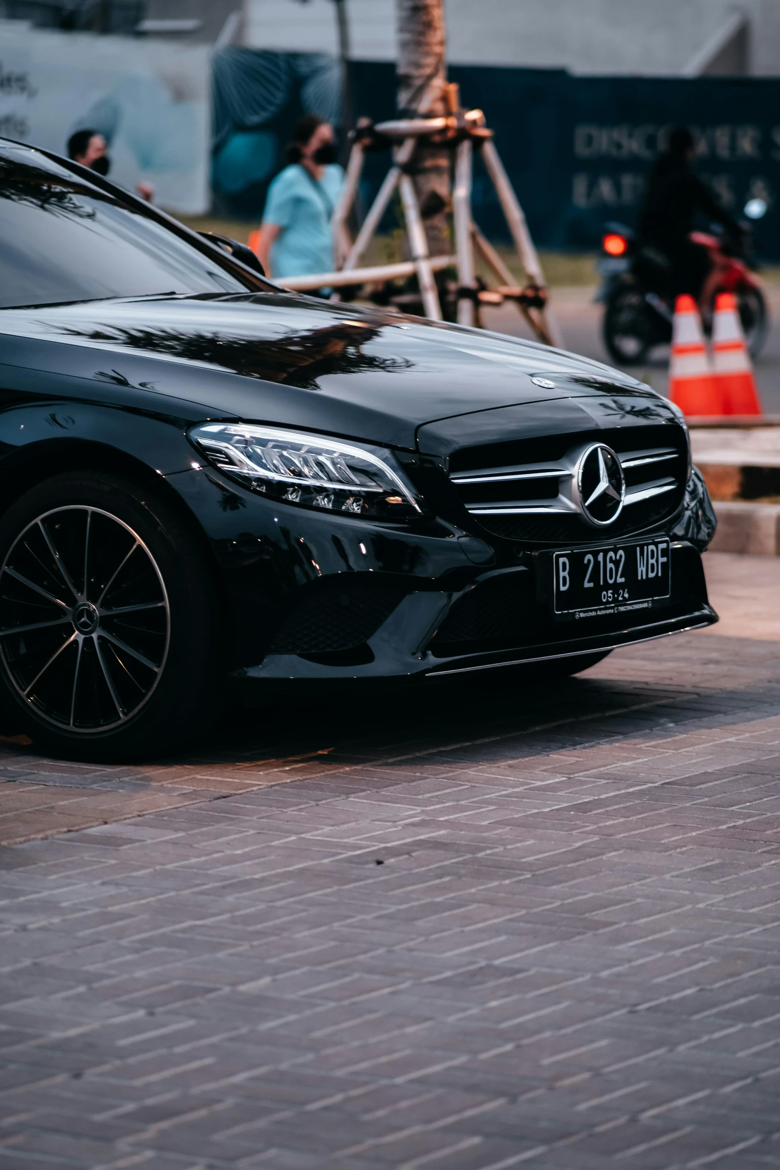 a black mercedes benz sports car with red ke lights