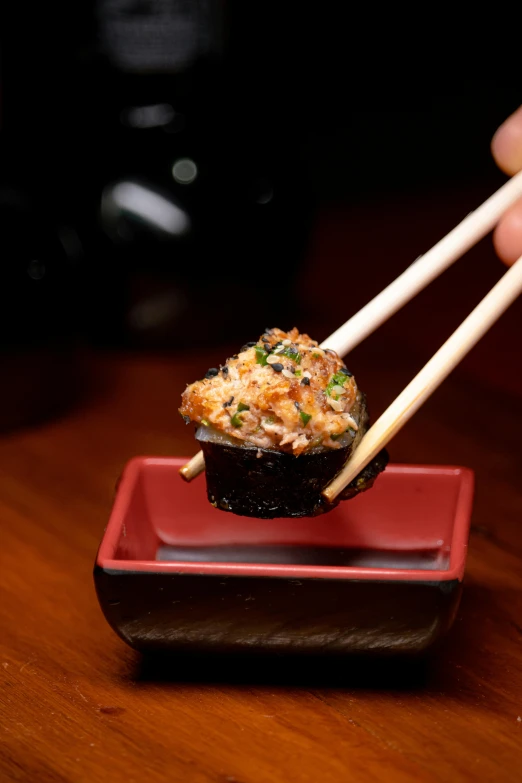 two asian chopsticks sitting on top of a small dish of food