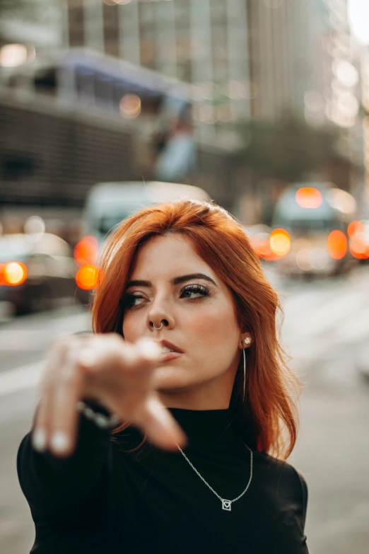 woman pointing her finger towards the camera in the city