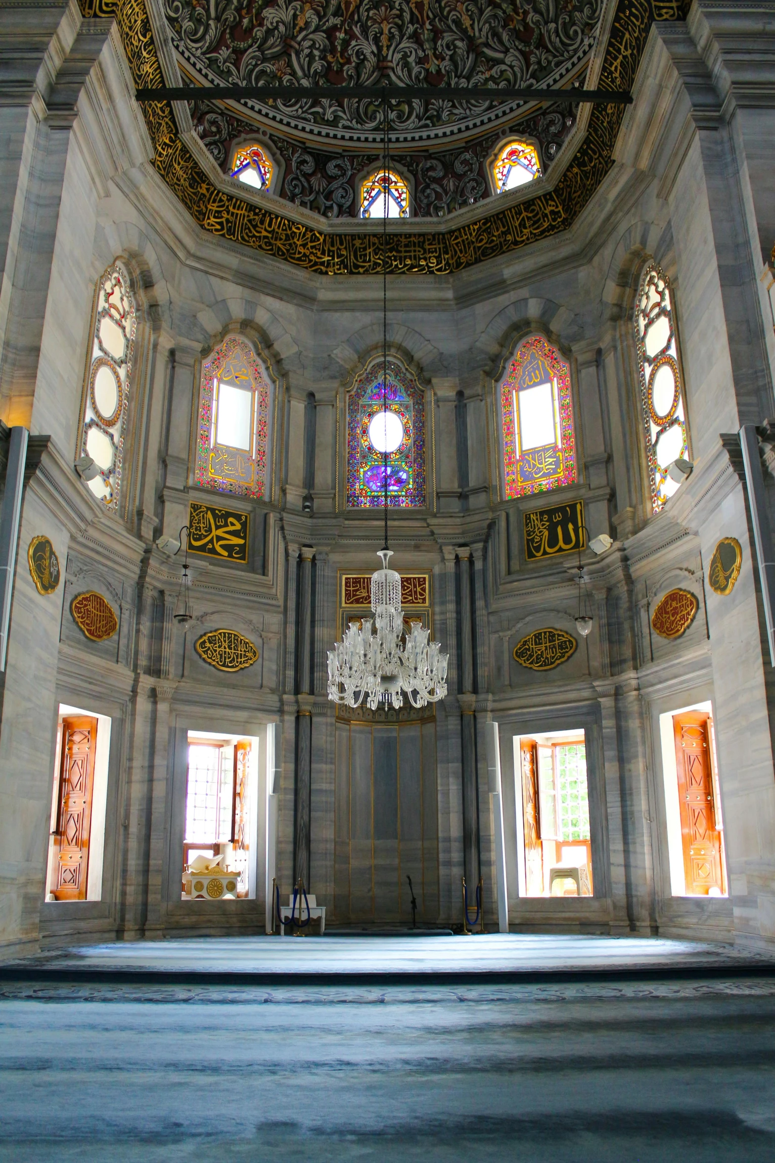 an elaborate interior of a building with ornate glass windows