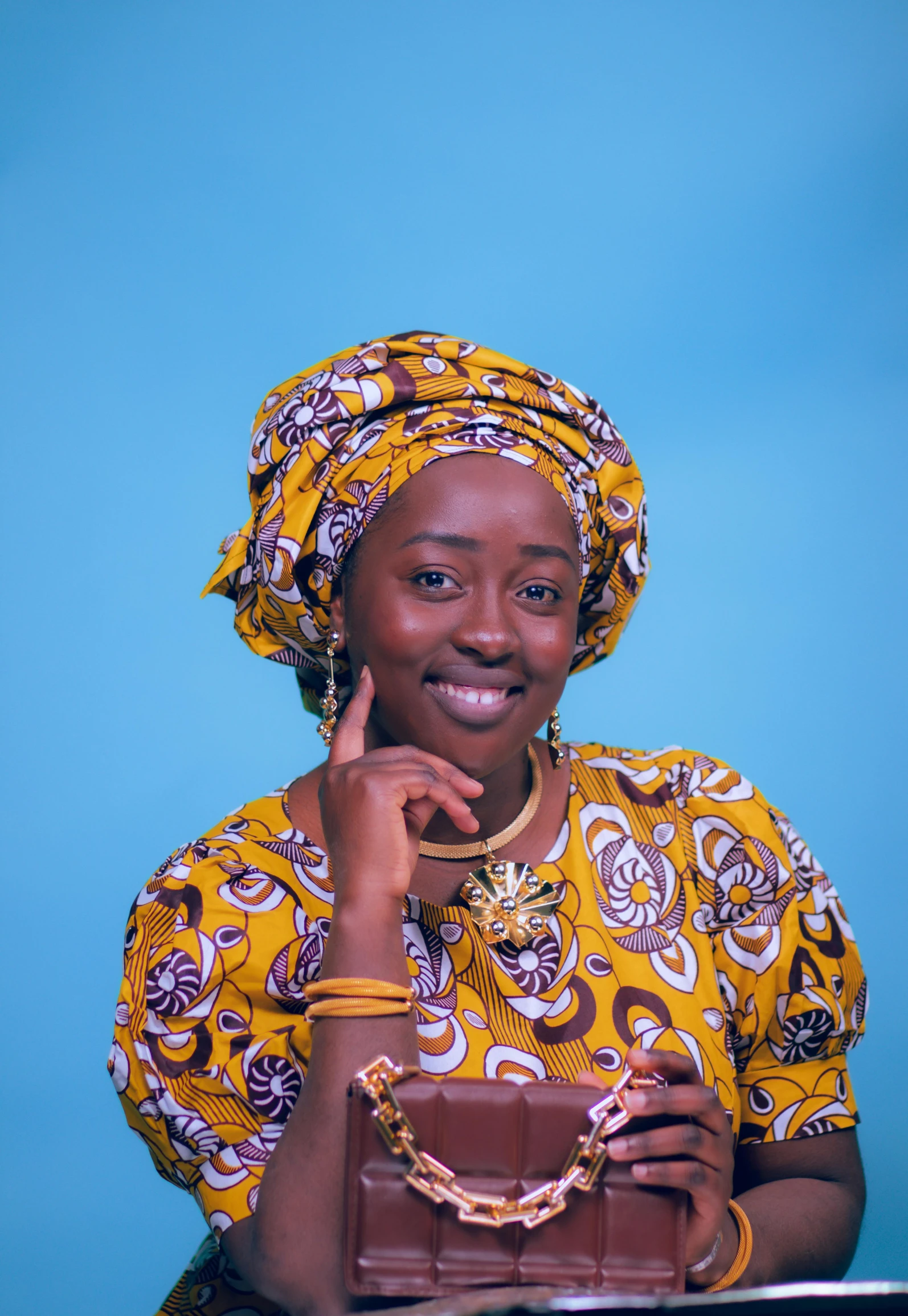 a woman holding a chocolate bag smiles for a po