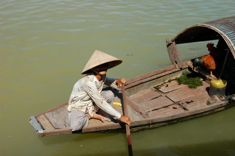 a woman is sitting in the boat with fruit and vegetables