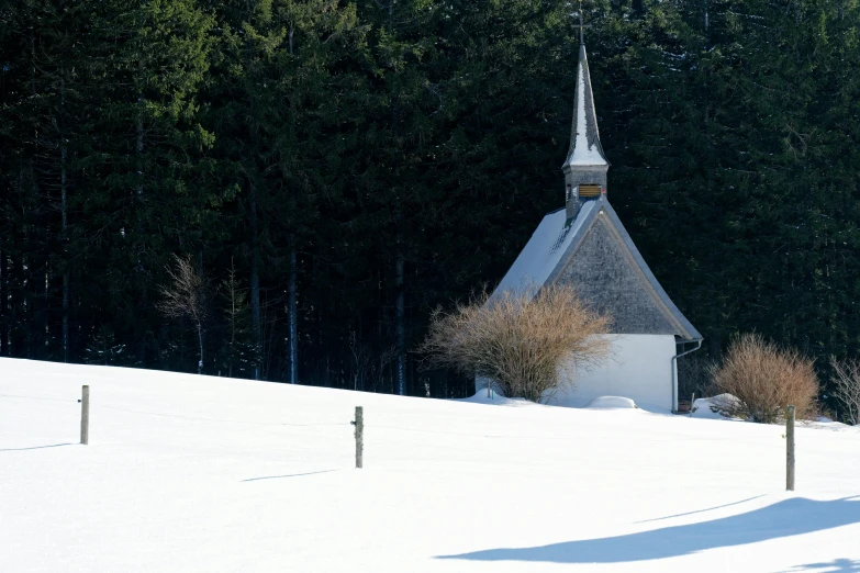 a church is in the background with snow on the ground