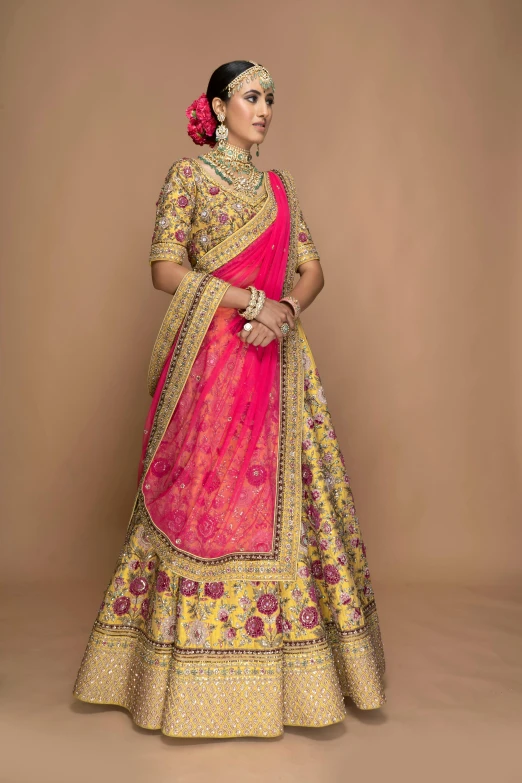 a woman in a yellow and pink sari
