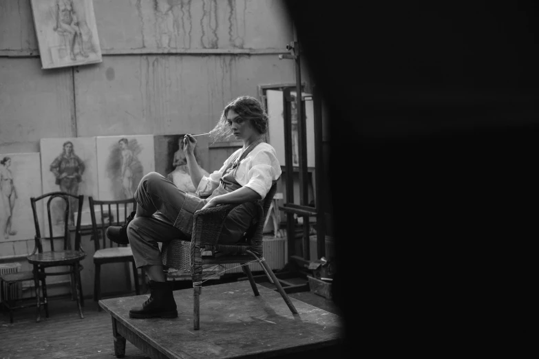 a woman sitting in a chair while drying her hair