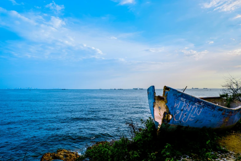 an abandoned boat on the edge of a cliff