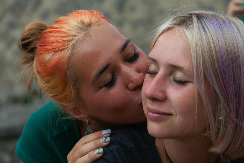 two beautiful women with pink hair posing for the camera