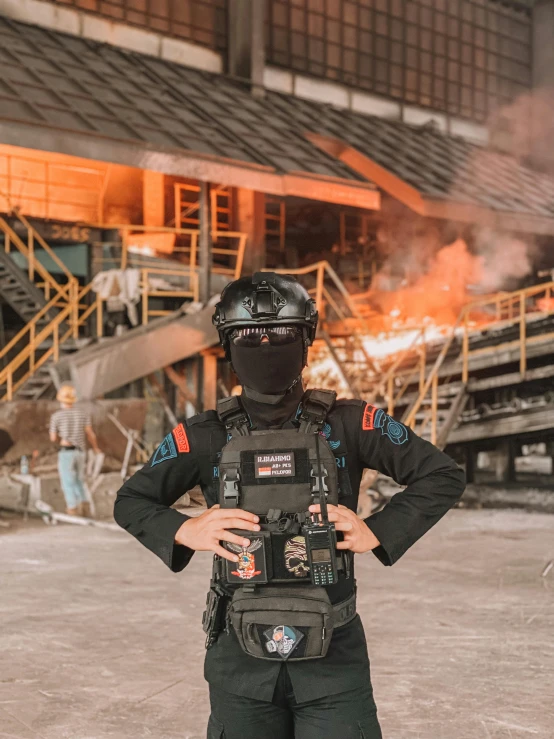 a man is standing in front of a fire