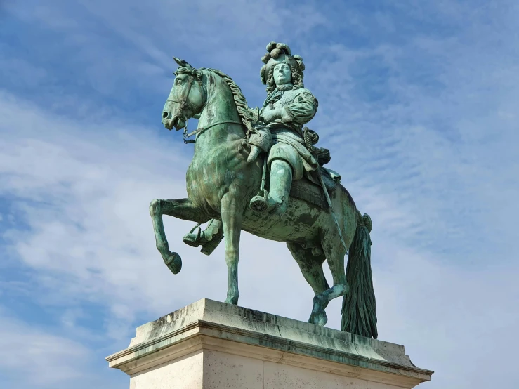 a statue of a man on a horse riding in the sky