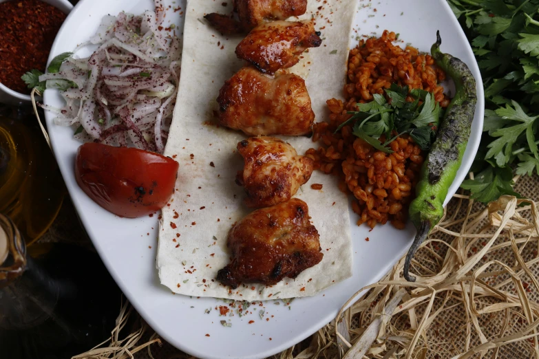 chicken and vegetable wrapped in tortilla paper on a plate