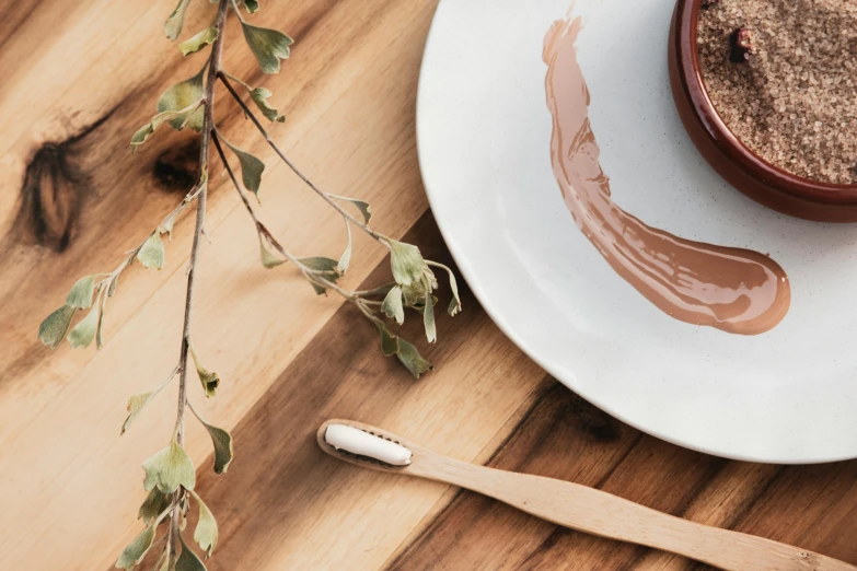 a white plate topped with brown food next to a cup of cocoa