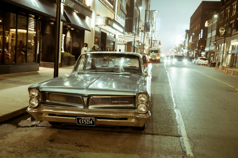 a car parked in front of a building at night