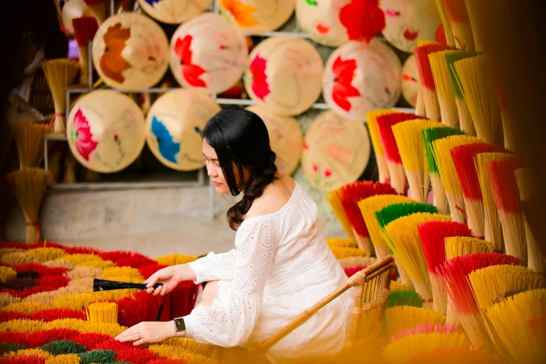 a woman cleaning some colorful rugs in a room