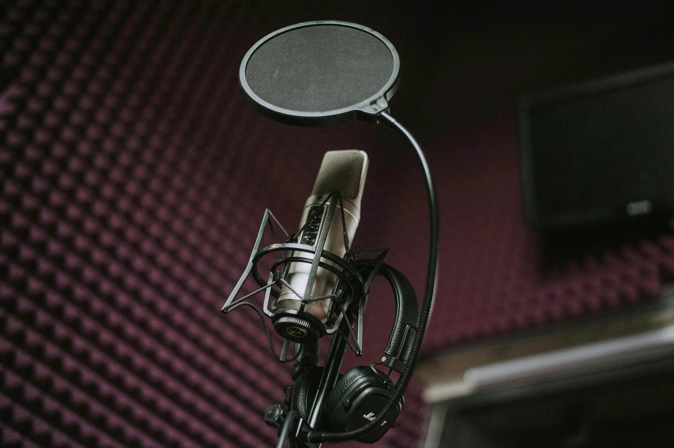 a microphone sitting next to a monitor on a desk