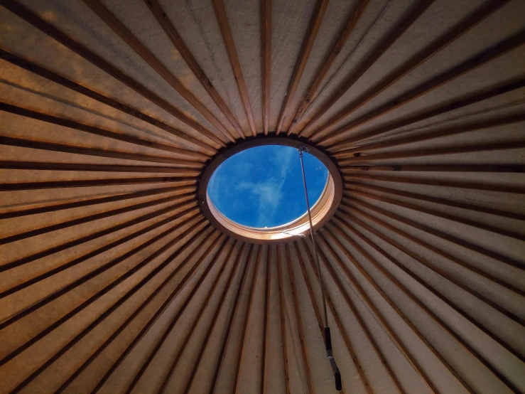 the interior of a dome roof that is made of wood