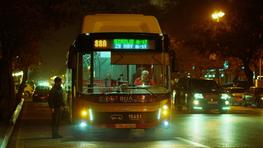 a double - decker bus turning onto a city street at night