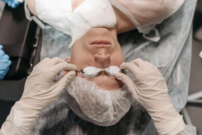 a person getting a facial procedure on by a doctor