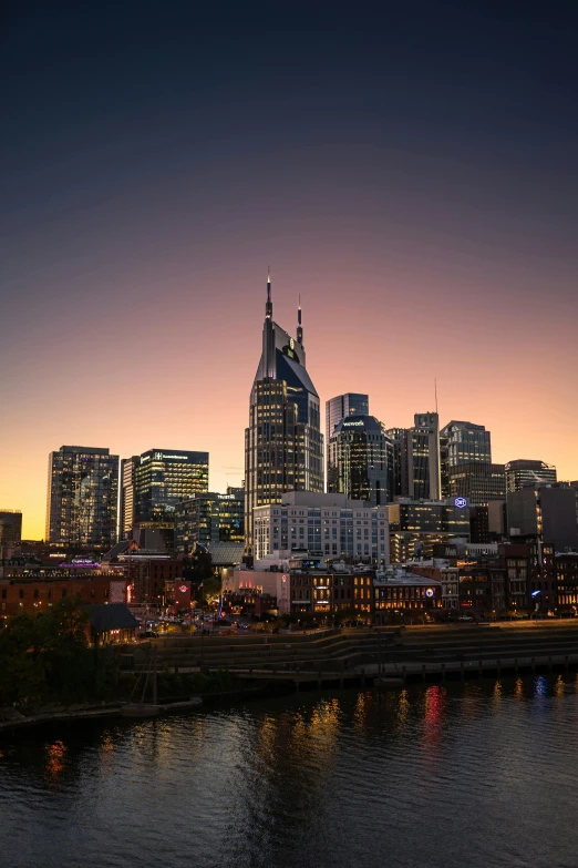 a view of some very tall buildings in the evening